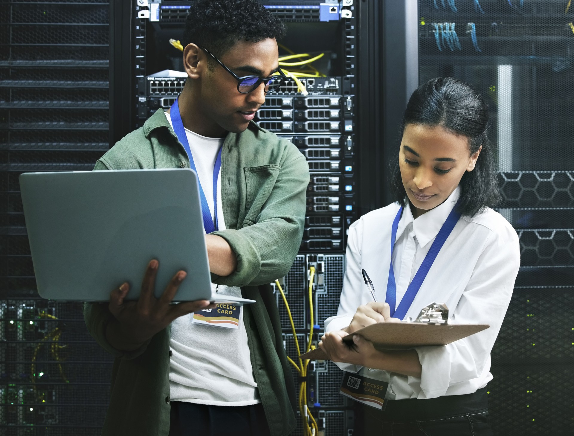 Shot of two technicians working together in a server room